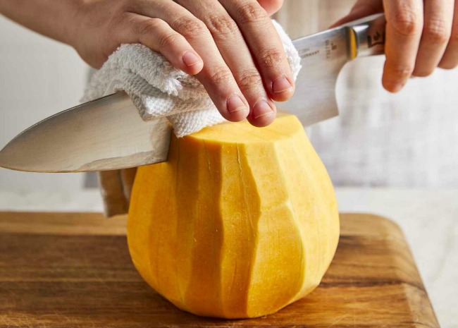 cutting up a peeled butternut squash